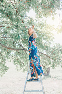  woman standing on ladder and picking berries on farm. happy farmer gather seasonal berries harvest 