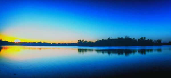 Scenic view of calm lake at sunset