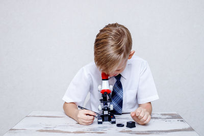 Boy looking at camera on table