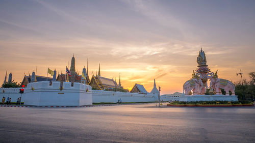 Traditional building against sky during sunset