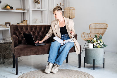 Beautiful hipster woman in casual cloth using laptop at home. cheerful woman using laptop