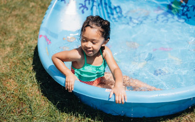 High angle view of cute girl in swimming pool