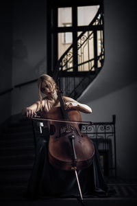 Young woman playing piano at home