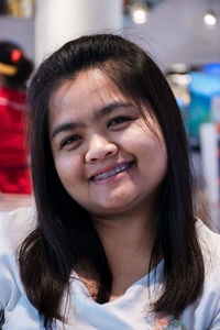 Close-up portrait of smiling young woman