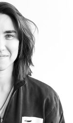 Portrait of a smiling young woman over white background