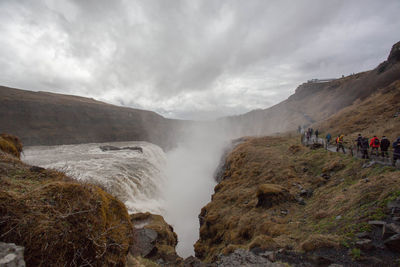 Scenic view of waterfall against sky