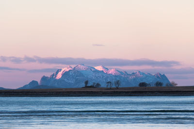 Scenic view of snowcapped mountains against sky during sunset