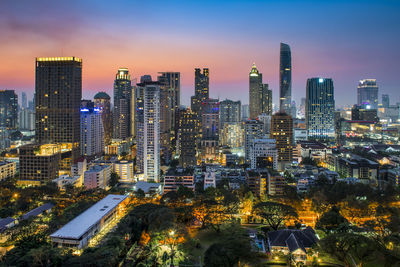 Illuminated cityscape against sky at night