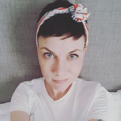 Portrait of woman wearing headband on bed at home