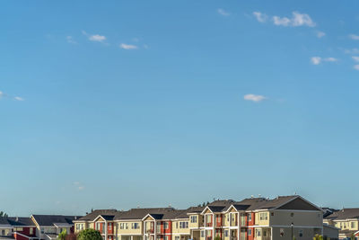 Low angle view of buildings against blue sky