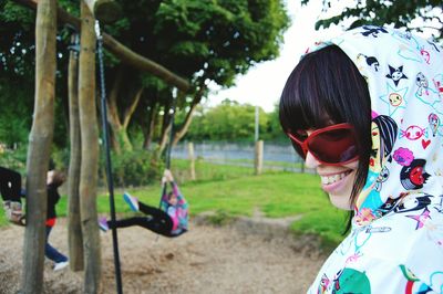 Rear view of woman standing by tree