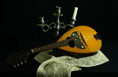 Close-up of guitar against black background