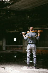 Rear view of man standing against wall