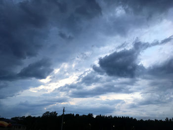 Low angle view of silhouette trees against sky