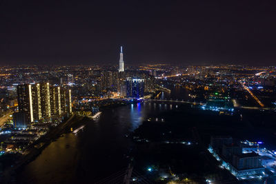 High angle view of city lit up at night