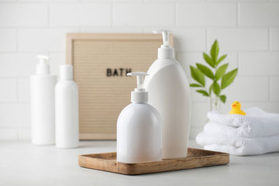 Blank plastic dispenser bottles with soap and shampoo for everyday in bathroom