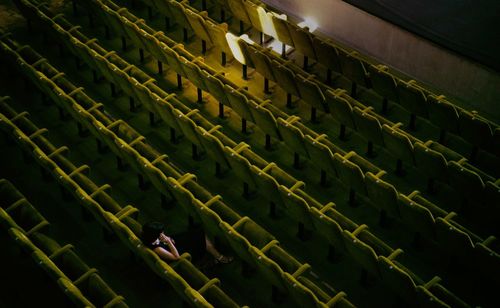 High angle view of woman sitting on chair in theater