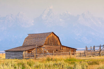 Barn on field against sky