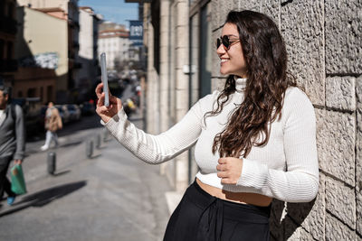 Woman standing on mobile phone