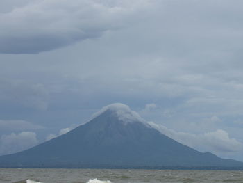 Scenic view of mountains against cloudy sky