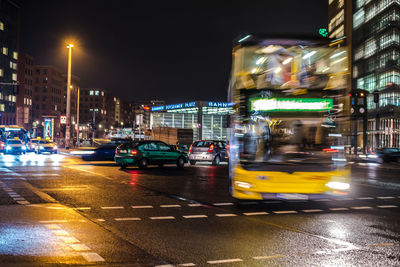 Cars on city street at night