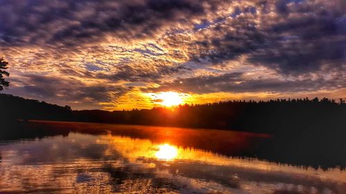 Scenic view of dramatic sky over landscape during sunset