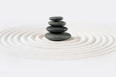 Black stones pile in the sand. zen japanese garden background scene