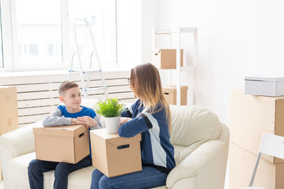 Young couple sitting in box