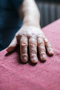 Old person's hand resting on table