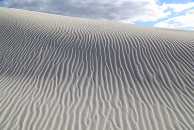 Sand dune in desert against sky