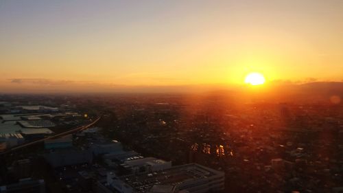 High angle view of buildings against romantic sky at sunset