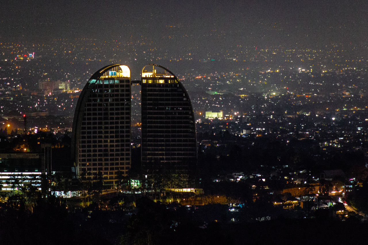 ILLUMINATED BUILDINGS AGAINST SKY AT NIGHT