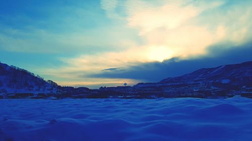 Scenic view of snow covered mountains against sky