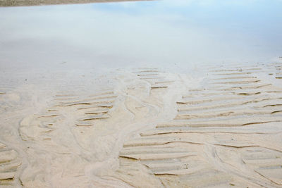 Close-up of sand on beach against sky