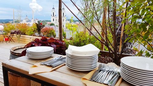 Stack of plates on table at outdoor restaurant