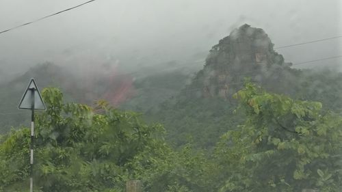 Scenic view of mountains in foggy weather