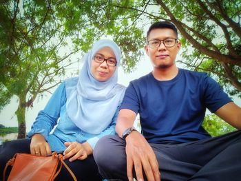 Portrait of couple sitting outdoors