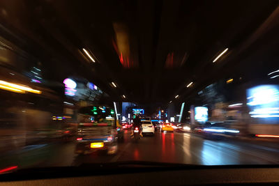 Blurred motion of bus on road in city at night