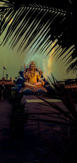 Low angle view of statues on building against sky