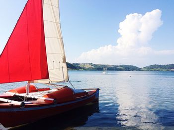 Sailboat sailing on sea against sky