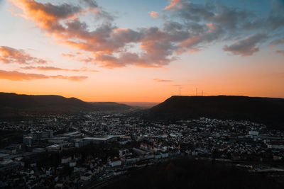 Sunset view over a german city with wind turbines, landscape format