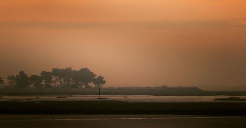 Scenic view of silhouette landscape against sky at sunset
