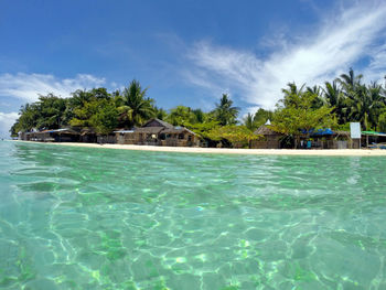 Scenic view of swimming pool by sea against sky