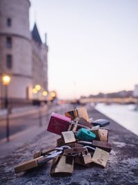 Close-up of love locks on retaining wall in city