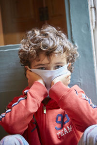 Close-up portrait of boy wearing mask