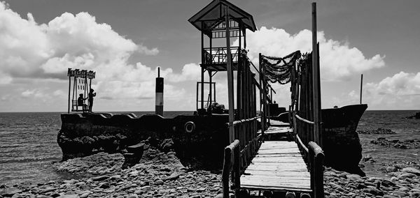 Lifeguard hut on beach against sky