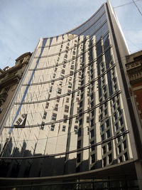 Low angle view of office building against sky