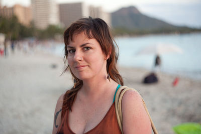 Portrait of woman standing at beach