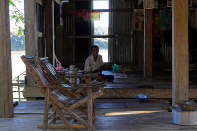 Woman sitting on chair at table