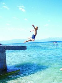 High angle view of woman jumping in water